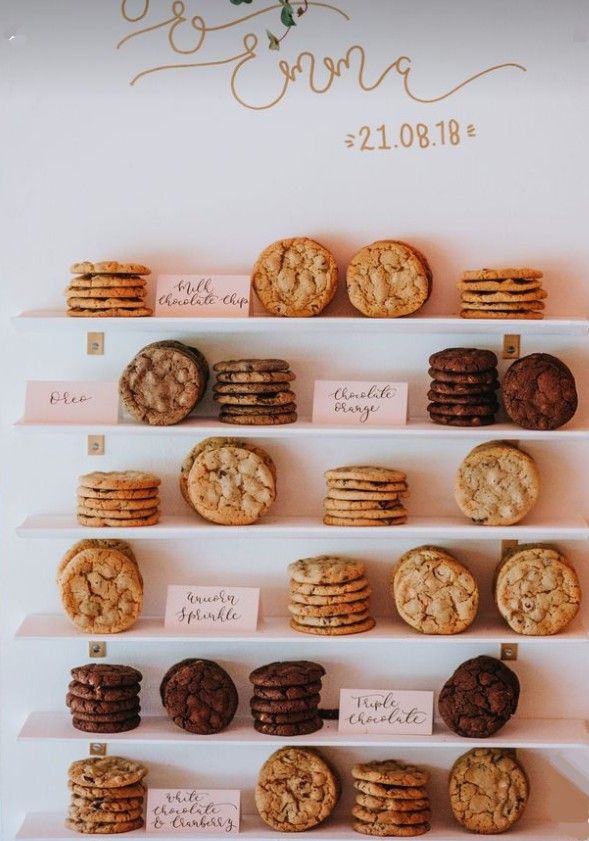 the cookies and cookies are displayed on the wall for guests to sign in their wedding day