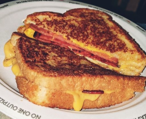 a grilled cheese and bacon sandwich on a plate