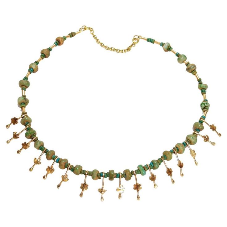 A fine Etruscan Revival style necklace. By the New York City Modernist female goldsmith Resia Schor. In 14k gold. Set with an alternating series of rough cut jade beads and stylized flower & bird gold drops on a gold wire and secured with a 14k gold safety catch. Designed with stylistic elements of the work of Resia's husband, Ilya Schor, Cubism, and Brutalism. Incorporating these elements in addition to a strong nod to the design of ancient jewelry of the Mediterranean, Resia Schor's work is strongly feminist, intensely modern, and a style wholly new. Resia Schor (née Ainstein) was a Jewish Polish-American artist who immigrated to New York in 1941 with her newlywed husband to escape the war in Europe. Resia obtained a degree in painting at the Academy of Fine Arts in Warsaw and exhibited Ceremonial Gold Choker Jewelry, Traditional Green Ceremonial Choker, Ceremonial Temple Jewelry Green Choker, Vintage Gold Handmade Choker, Vintage Green Choker Necklace, Flower Bird, Rough Cut, Ancient Jewelry, Creating Jewelry