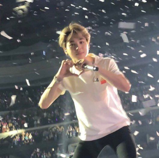 a man standing on top of a stage with confetti falling from the air