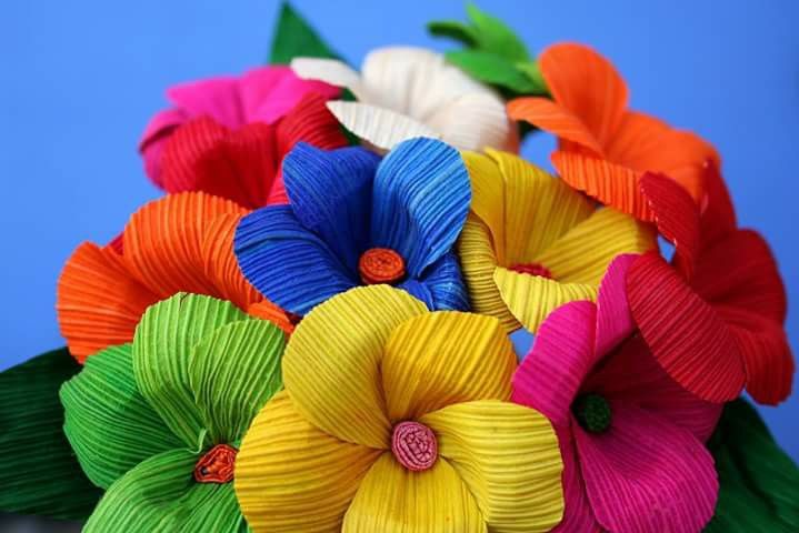 colorful paper flowers are arranged in a bouquet