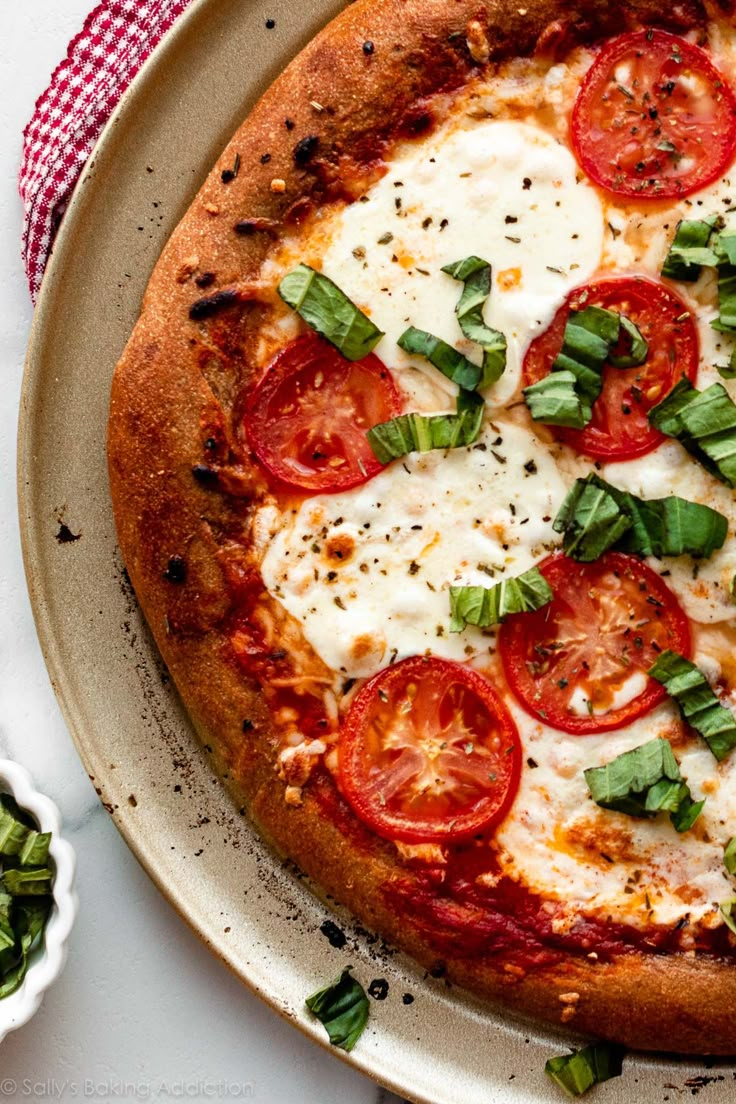 a pizza topped with tomatoes and cheese on a plate