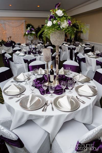 the tables are set with white and purple linens