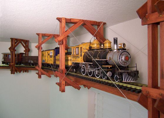 a toy train is sitting on top of a shelf in a room with white walls