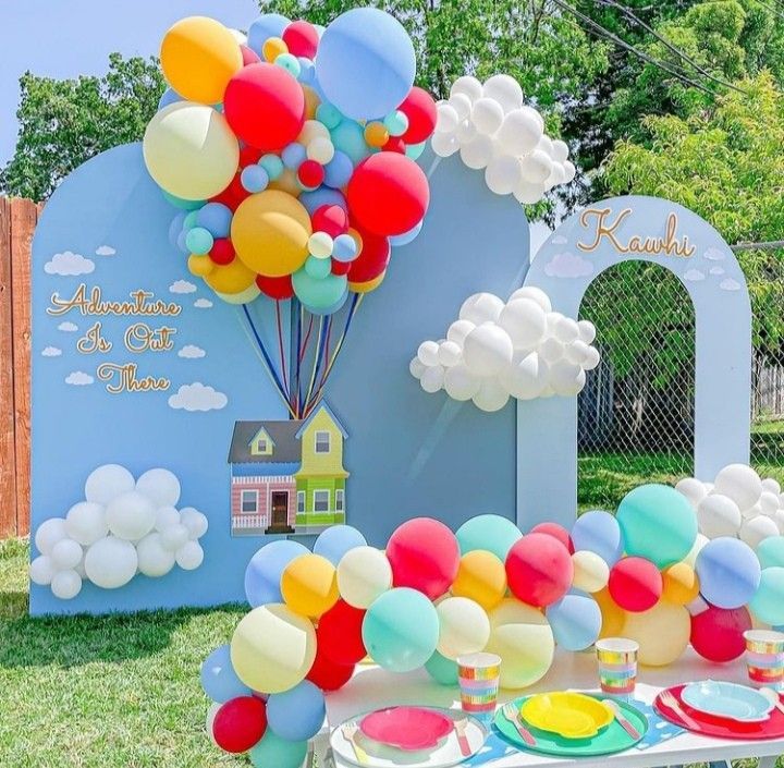 a table with balloons and plates on it