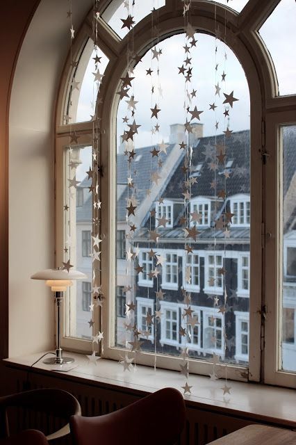 a large window with stars hanging from it's side