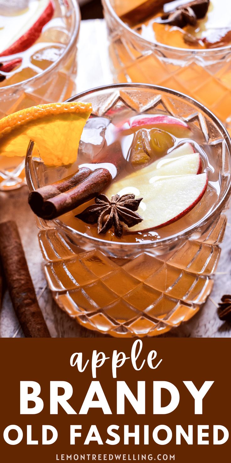 an apple brandy old fashioned cocktail in a glass bowl with cinnamons and apples on the side