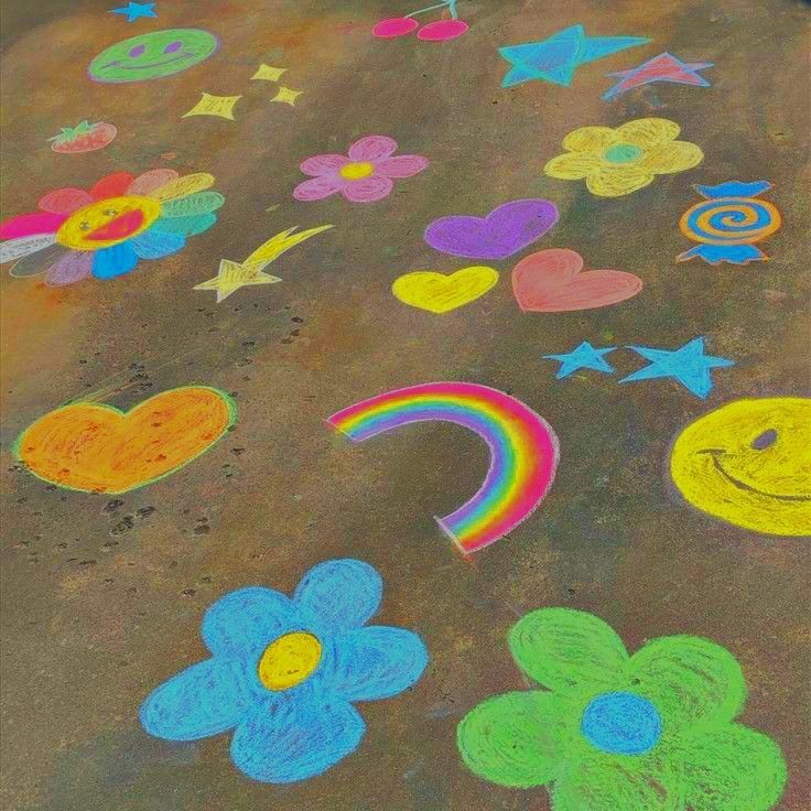 colorful chalk drawings on the ground with flowers, hearts, and other things drawn by children