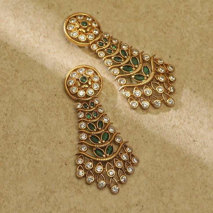 Description This Tarinika earrings are truly elegant. It features kempu and CZ stones arranged in a beautiful design creating an attractive contrast with its antique-gold tone plating. The design's simple elegance makes it suitable for weddings and special events. Style them on lehengas or tunics. Details & Specifications: Materials used: Brass Alloy with Antique Plating Weight - Earrings 13 gm Length - Earrings 5.5 cm Make it custom Want to make it a custom earring? Sure! Reach out to us at sup Antique Gold Jewelry Indian Unique, Trending Gold Earrings, Indian Jewellery Aesthetic, Vintage Indian Jewelry, Victorian Style Earrings, Indian Designs, Churidar Designs, Fancy Jewelry Necklace, Gold Earrings Wedding