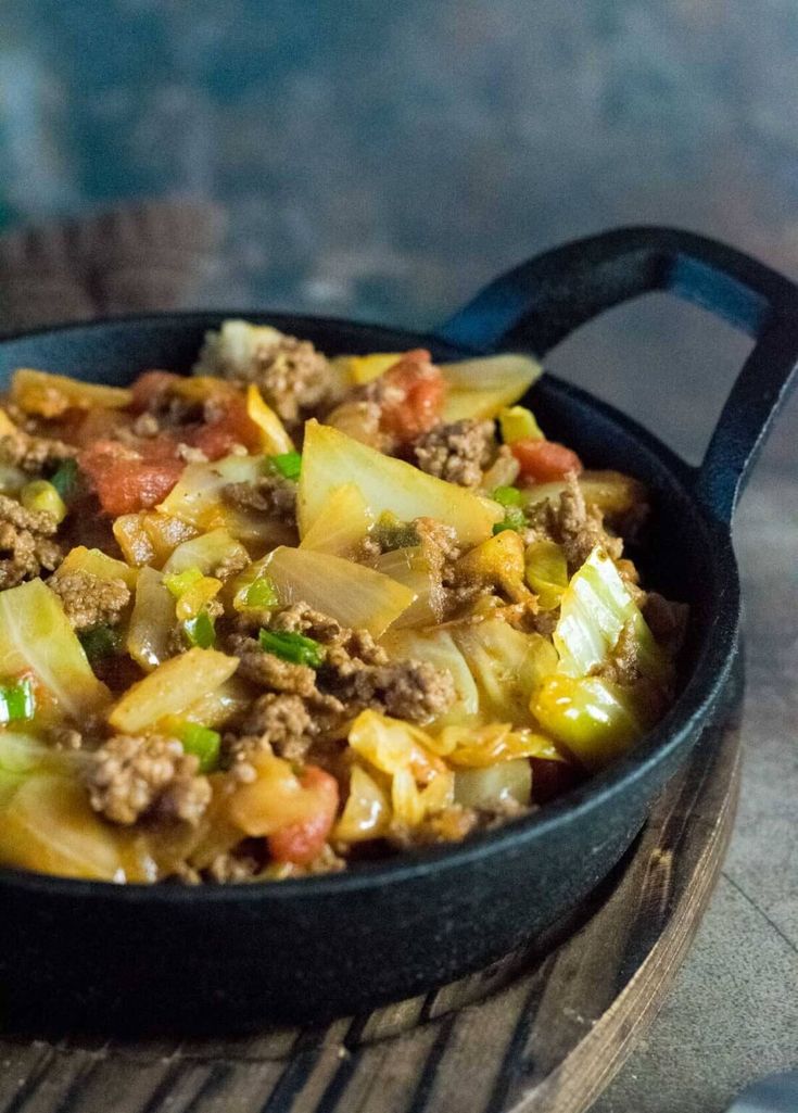 a skillet filled with food sitting on top of a table