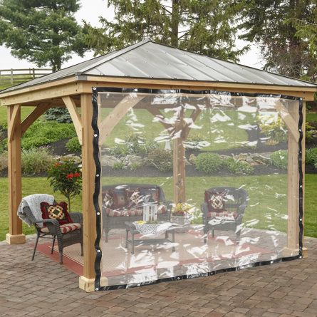 a wooden gazebo sitting on top of a brick patio