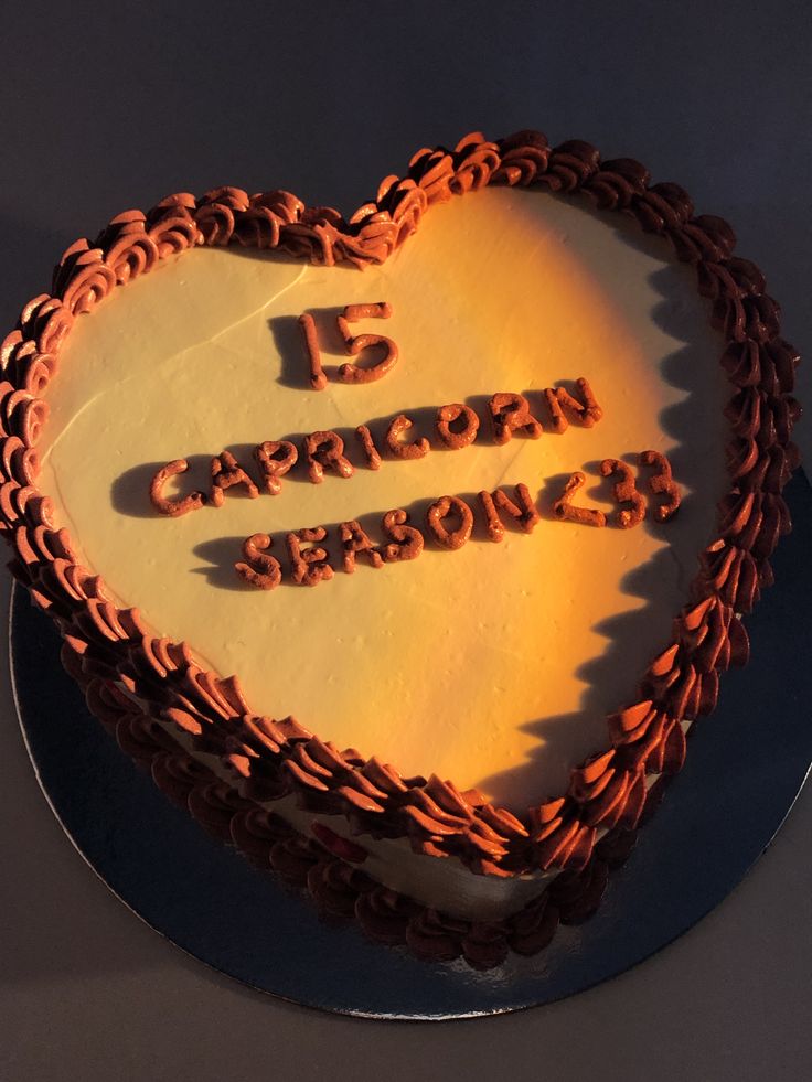 a heart shaped cake with the number five written on it and some type of writing in the middle