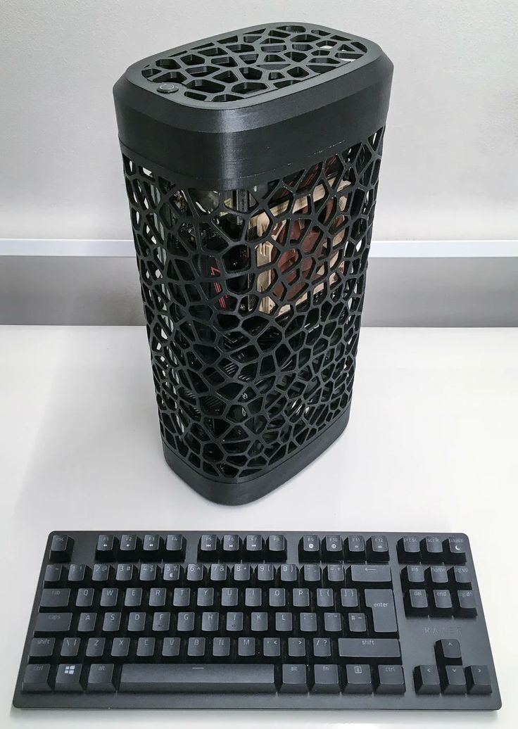 a computer keyboard sitting next to a trash can