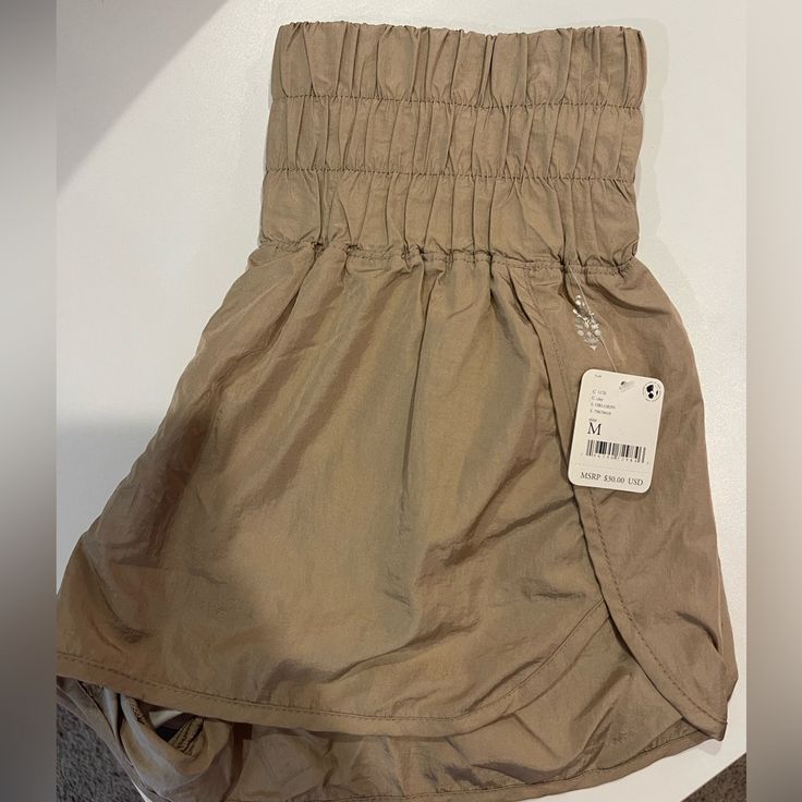 a pair of khaki shorts with a price tag on them