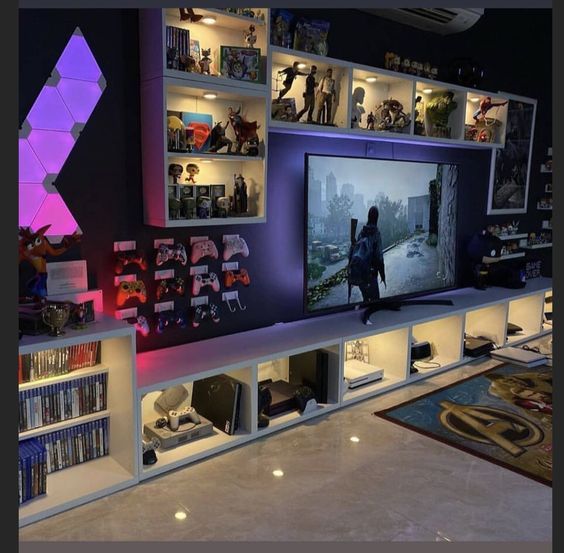 a large entertainment center with shelves filled with movies and video game memorabilia on the wall