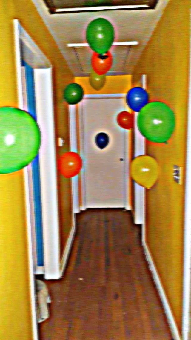 the hallway is decorated with balloons and streamers