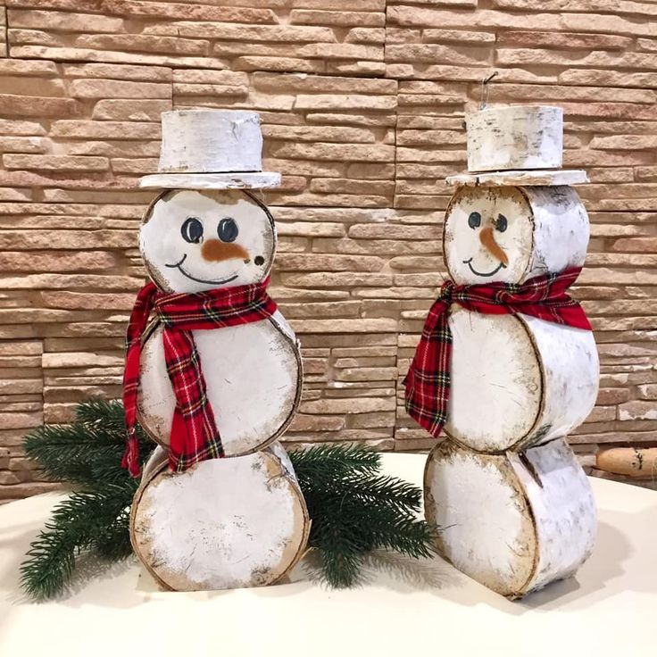 two snowmen are standing next to each other