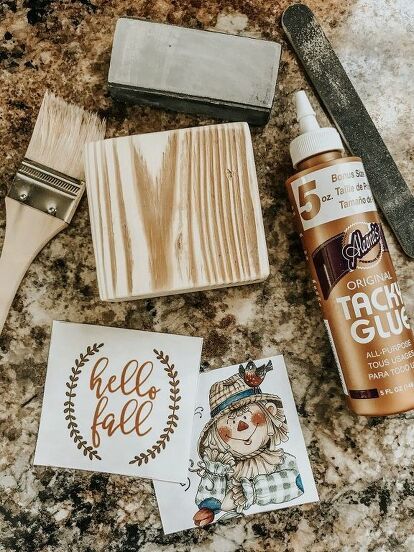 some crafting supplies are laying out on the counter next to a brush and glue