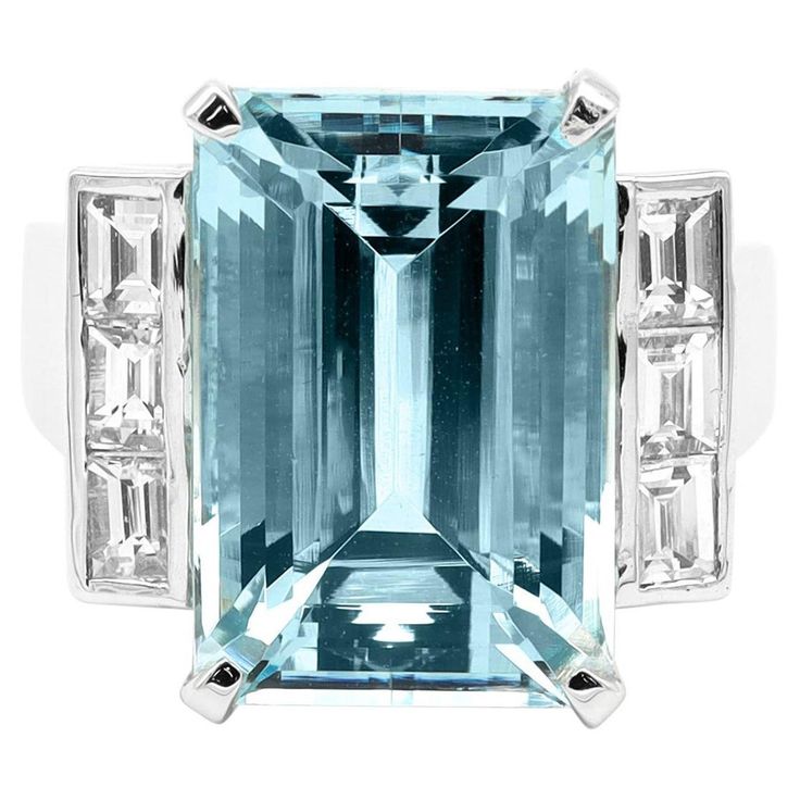 18 Karat White Gold 11.01 Carat Aquamarine Emerald-Cut Statement Cocktail Ring This marvelous cascading blue aquamarine and diamond ring is a statement piece. The solitaire long emerald cut aquamarine in grain prong setting is brilliantly combined with three identical matching princess square diamonds on either side in a bezel setting, to accentuate the center aquamarine. The heightened white gold shank holding the stones from the sides and the graduating solid gold band add profundity to this c Aquamarine Cocktail Ring, Summer Rings, Solid Gold Band, Aquamarine Engagement Ring, Family Jewellery, Aquamarine Stone, Square Diamond, Aquamarine Rings, Handmade Rings