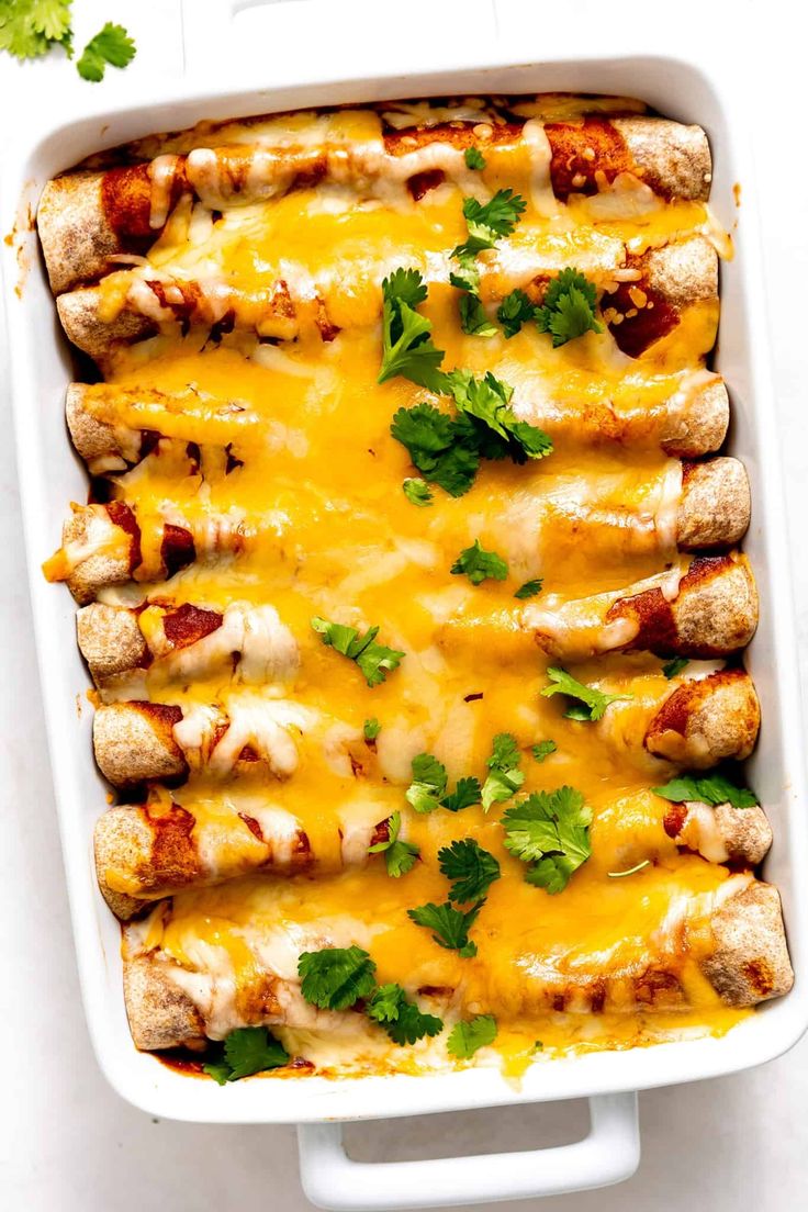 chicken enchilada casserole with cheese and cilantro on top