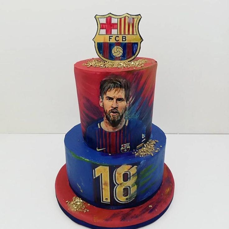 a multi layer cake decorated with the image of messel neves and barcelona crest