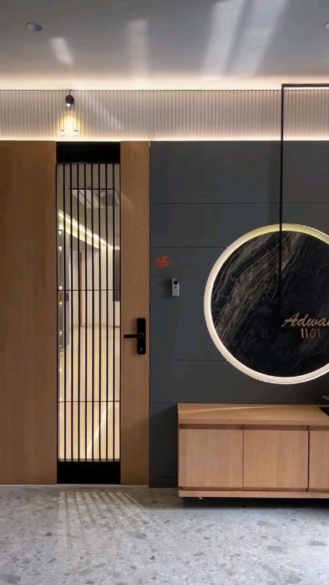 the entrance to an office building is decorated with black and white marble, gold accents