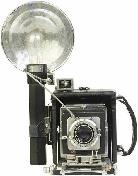 an old fashioned camera with a light on it