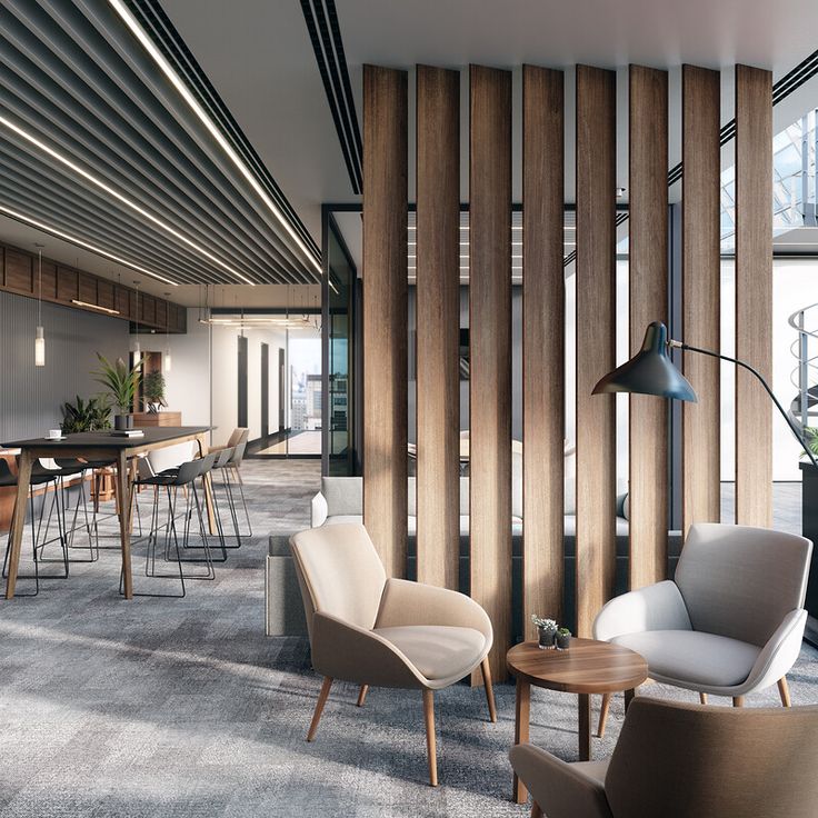 an office with chairs and tables in the middle of it, along with wooden partitions