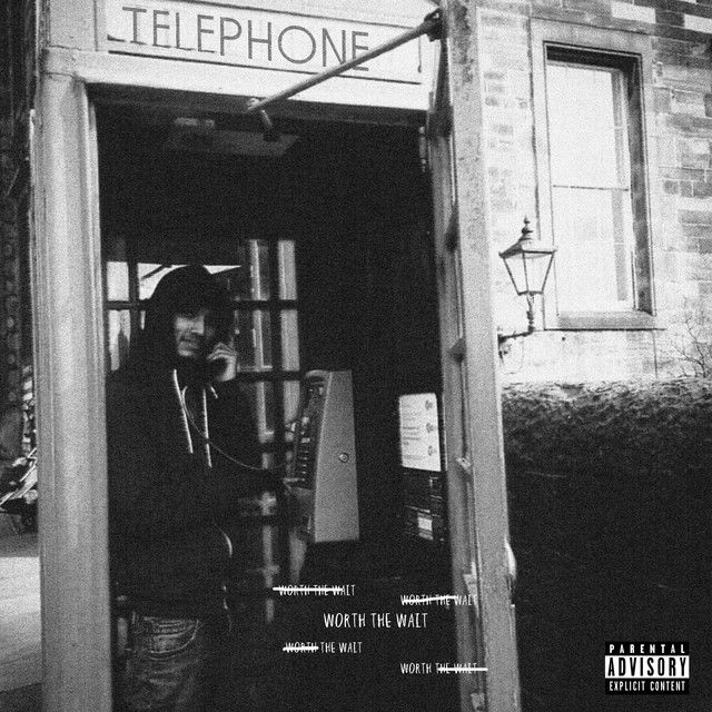 a man standing in the doorway of a telephone booth