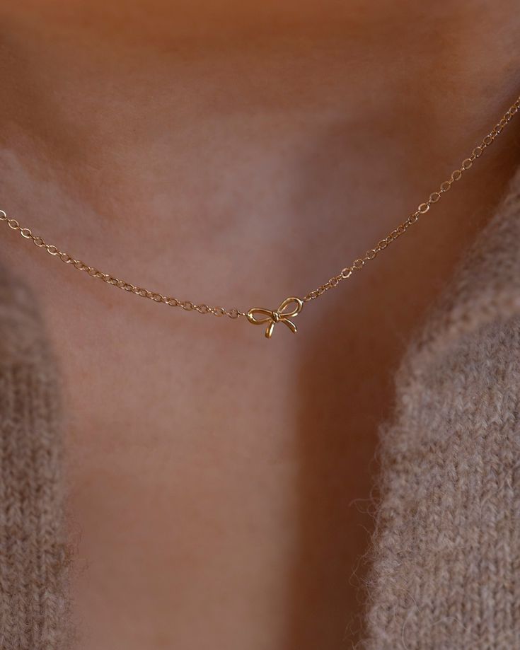 Discover the charm of the coquette era with our 14k Gold Dainty Bow Necklace. The small, delicate bow is ideal for everyday wear, making it a must-have accessory. • 14k Yellow Gold• Bow measures about 6mm Elegant Tiny Charm Necklaces In 14k Gold Filled, Handmade Gold Necklace, Preppy Jewelry, Pretty Jewelry Necklaces, Small Necklace, Gelang Manik, Set Earrings, Bow Necklace, Jewelry Accessories Ideas