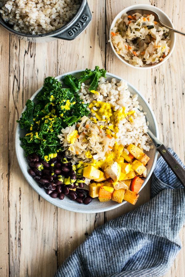 a bowl filled with rice and vegetables next to two bowls of beans, broccoli