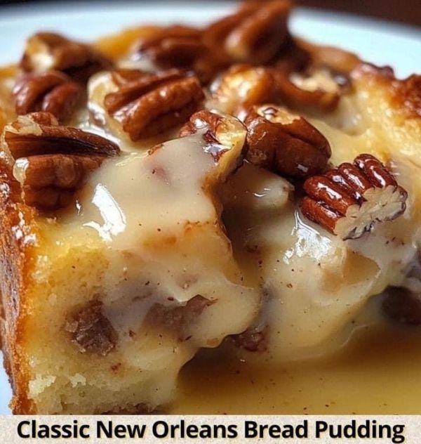 a piece of bread with pecans on top and cheese sauce drizzled over it