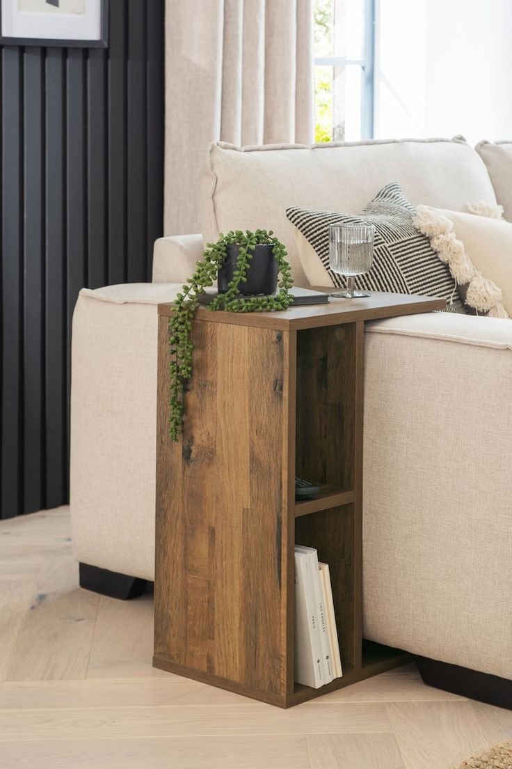 a living room with a couch, table and bookshelf on the floor in front of it