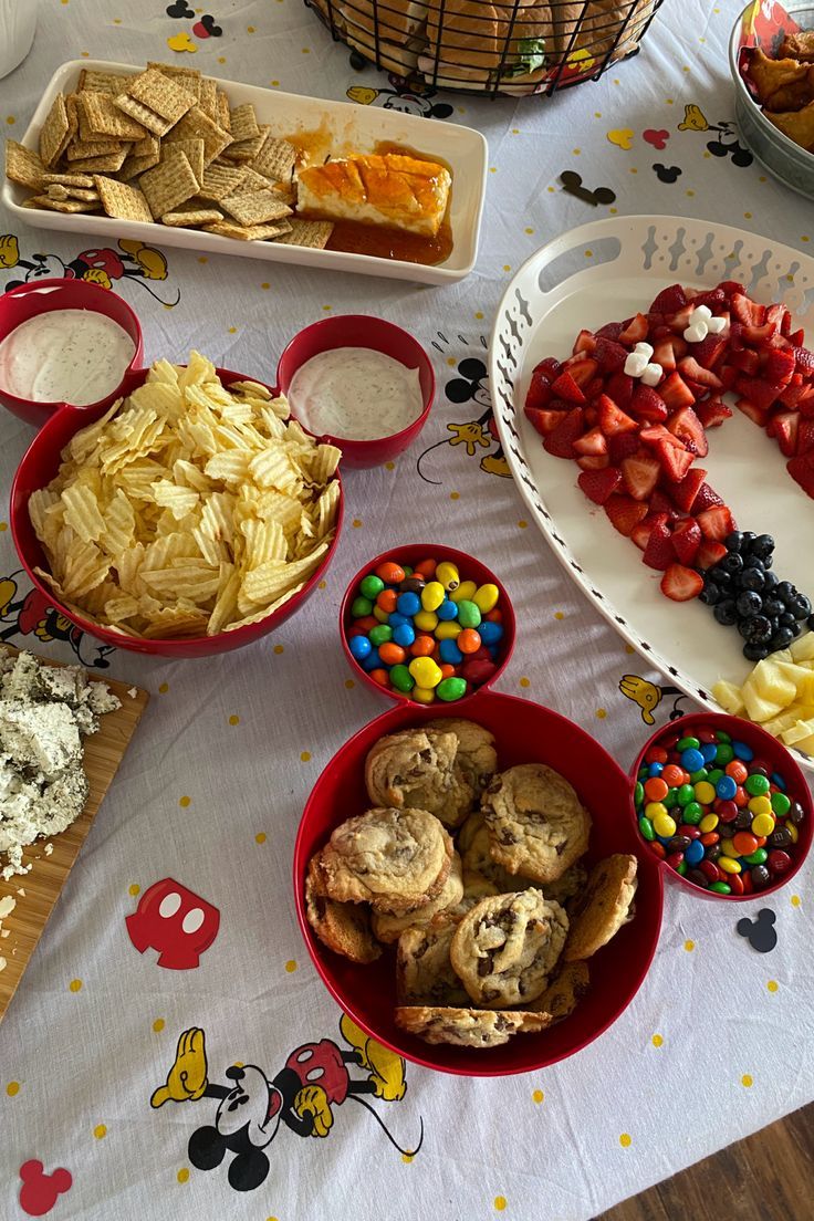 a table topped with lots of different types of snacks and desserts next to each other