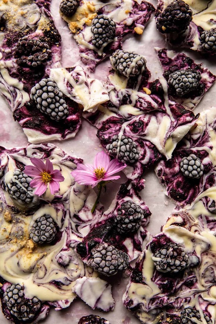 a dessert with raspberries and blackberries on it