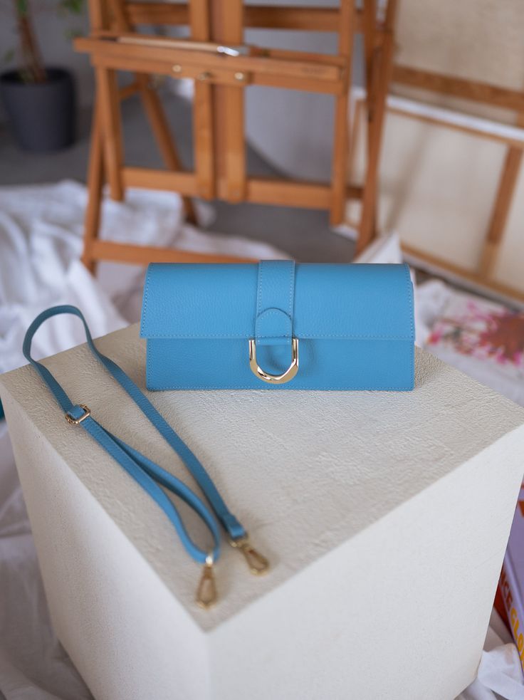 Stunning rectangular bag with a golden buckle and comes with two straps, one short and one long. Whether dressed up or down, this bag is sure to add a touch of elegance to any outfit and is perfect for any occasion. Colors: blue - green - pink Length 11.03 in - Width 1.97 in Contexture: genuine leather Elegant Blue Shoulder Bag With Fold Over Clasp, Trendy Blue Top Handle Baguette Bag, Elegant Rectangular Detachable Bag Strap, Blue Rectangular Flap Bag For Formal Occasions, Trendy Blue Rectangular Baguette Bag, Elegant Blue Baguette Bag With Detachable Strap, Elegant Blue Baguette Bag For Evening, Formal Blue Rectangular Flap Bag, Blue Rectangular Flap Bag