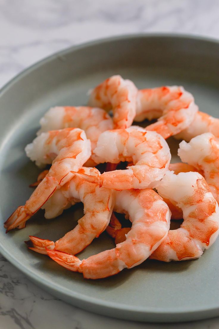 some shrimp is sitting on a plate and ready to be eaten