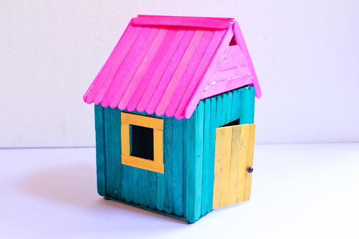 a small toy house with a pink roof