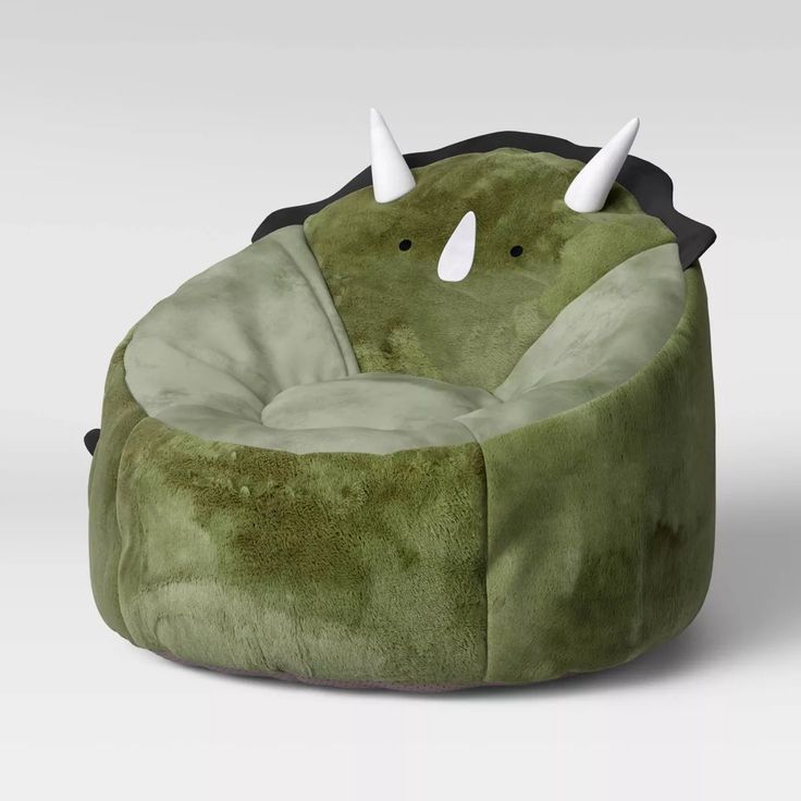 a green bean bag chair with horns on it