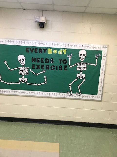 a sign with skeletons on it that says every body needs to exercise