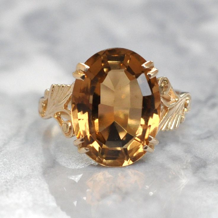 9ct Yellow gold ring with a single oval citrine in a claw setting. Hallmarked and dated Birmingham UK 1976. Weight: 5.5 grams Size: UK - T   USA - 9 3/4 Citrine Measures:  12.1 mm x 16.0 mm Each and every piece listed by Vintage Fine Jewellery has been restored by hand in our London workshop by highly skilled jewellers. Our jewellers use the same expertise to restore a piece of jewellery, as were used in their creation many years ago. If you would like to see more of the Vintage Fine Jewellery Collection, visit us at: www.vintagefinejewellery.com We ship all of our sales free of charge using Royal Mail Special Delivery. REF: V1894 Victorian Diamond Ring, Amethyst Cocktail Ring, Green Amethyst Ring, Head Ring, Vintage Fine Jewelry, Garnet Bracelet, Citrine Ring, Green Amethyst, Fine Jewelry Collection