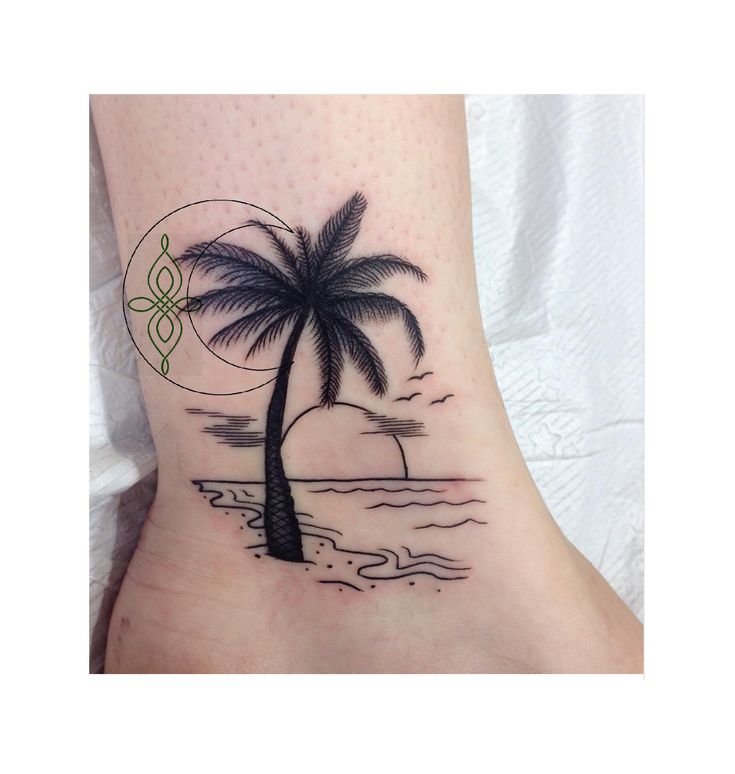 a small palm tree on the ankle tattoo design for women and men, with an ocean scene in the background