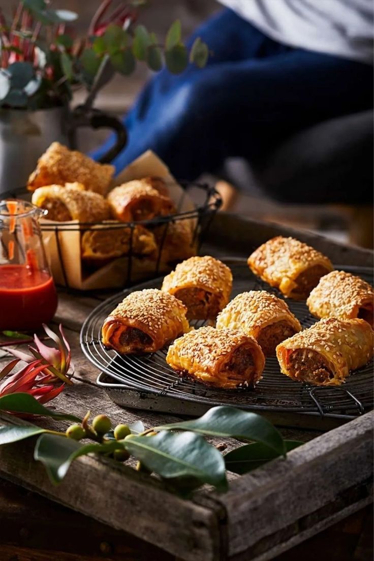 several pastries are on a tray next to some condiments