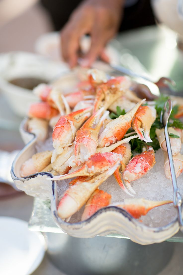 a platter filled with cooked shrimp and garnished with parsley on ice