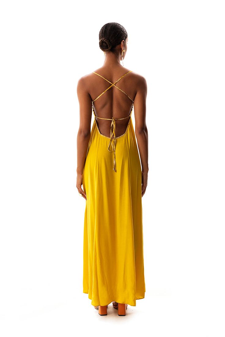 This garment is made from Natural Vegan Fabric 🌱 53% Cupro 47% Viscose Rayon & 100% Viscose V-neck color-blocked dress in the front Straps detailed with gold metal accessories are tied through the channels on the back Deep V-neckline on the back The draped fabric has a soft and slightly shiny appearance The center has a pattern detail The size worn by the model in the picture is S  This material, which leaves no carbon footprint, is produced with an innovative vegan textile process that ensures that there is no animal material from beginning to end. The soft silky fabric is kind to you as well as to the world. Oeko Tex 100 Certified  100% Recyclable and Sustainable  --- Suitable for dry cleaning Machine wash max 30C Warm iron max 150C Can be tumble dried Dry Flat Do not use chlorine-based Yellow V-neck Vacation Dress, Yellow Bohemian Maxi Dress With V-neck, Yellow Bohemian V-neck Maxi Dress, Yellow Cotton Maxi Dress With V-neck, Yellow V-neck Maxi Dress Beachwear, Silky Fabric, Viscose Rayon, Metal Accessories, Draped Fabric