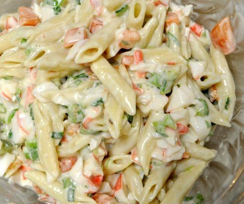 a bowl filled with pasta salad on top of a table