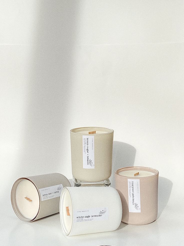 three candles sitting next to each other on a white surface with one candle in the middle