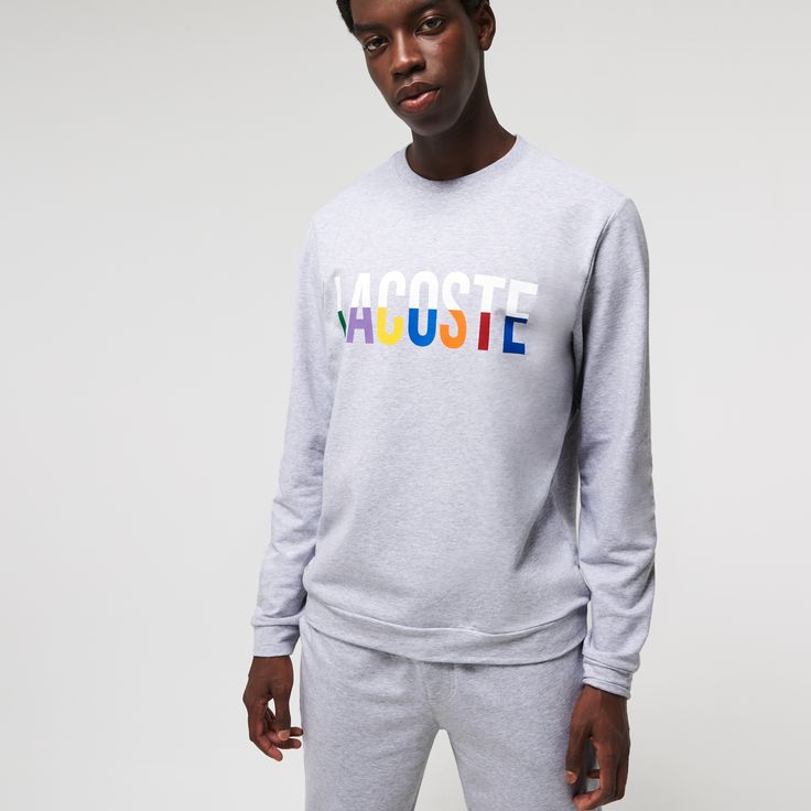 Adorned with oversized multicolor brand lettering, this solid lounge sweatshirt is perfect for kicking back. Crafted in soft cotton blend fleece, it has a classic straight cut and a ribbed crew neck. Get the total look when you pair it with the coordinating pants. Crew Neck Sweats With Letter Print For Spring, Spring Crew Sweatshirt With Logo Print, Relaxed Fit Logo Print Sweatshirt For Spring, Logo Print Sweatshirt For Spring Loungewear, Winter Athleisure Sweatshirt With Logo, Winter Crew Neck Sweatshirt With Logo, Fall Fleece Sweater With Logo Print, Winter Loungewear Sweatshirt With Logo, Fall Crew Neck Sweats With Logo Print