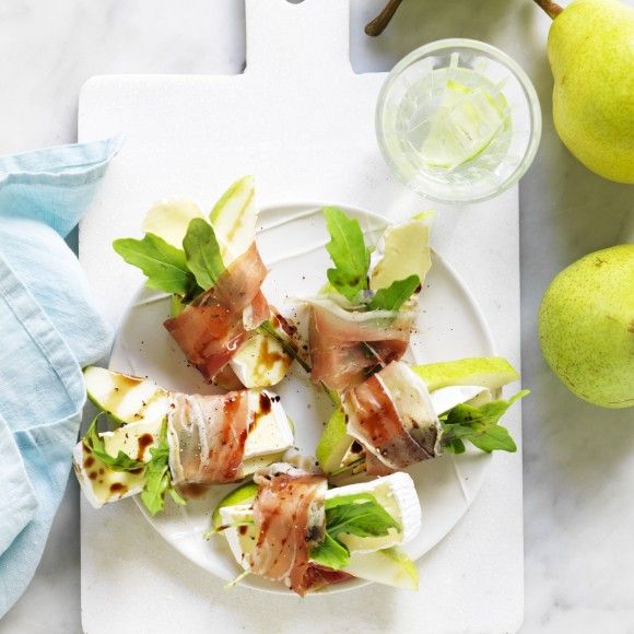 a white plate topped with food next to pears