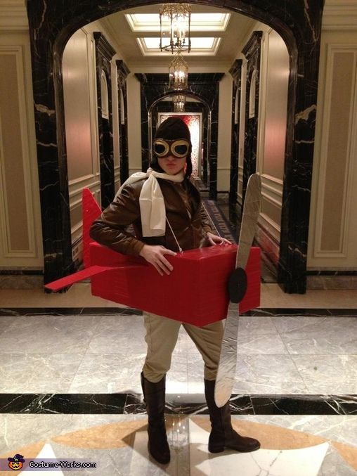 a man dressed in costume and holding a giant pair of scissors standing next to an elevator